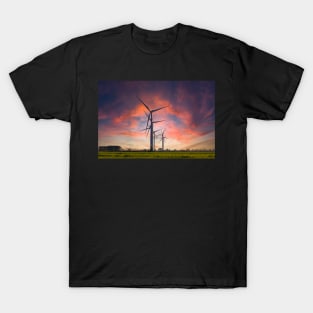 Windmill farm on green meadow under moody red sky T-Shirt